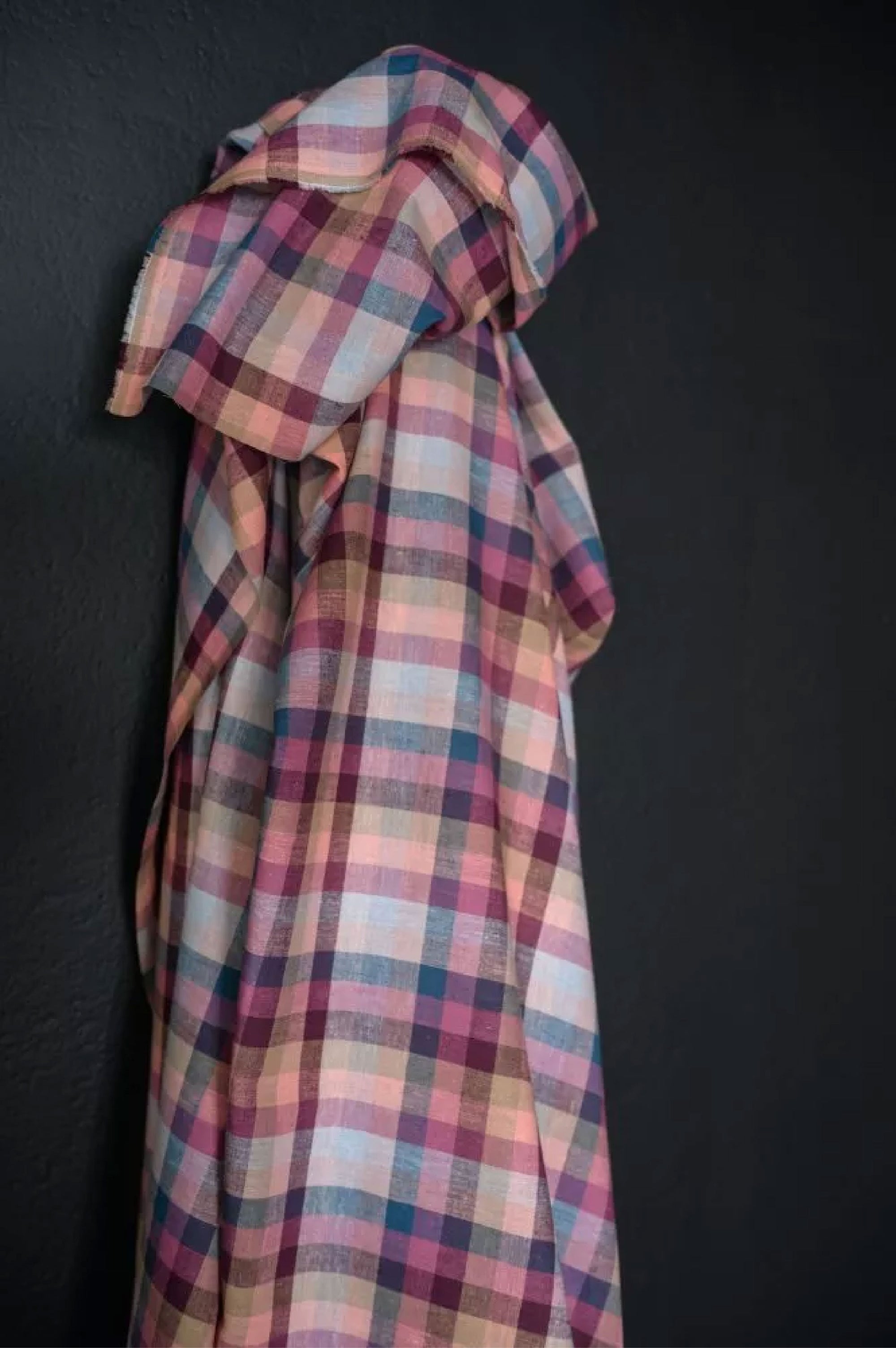 cotton and linen blend in the shade range of pinks, blues and purple gingham on a dark grey background.