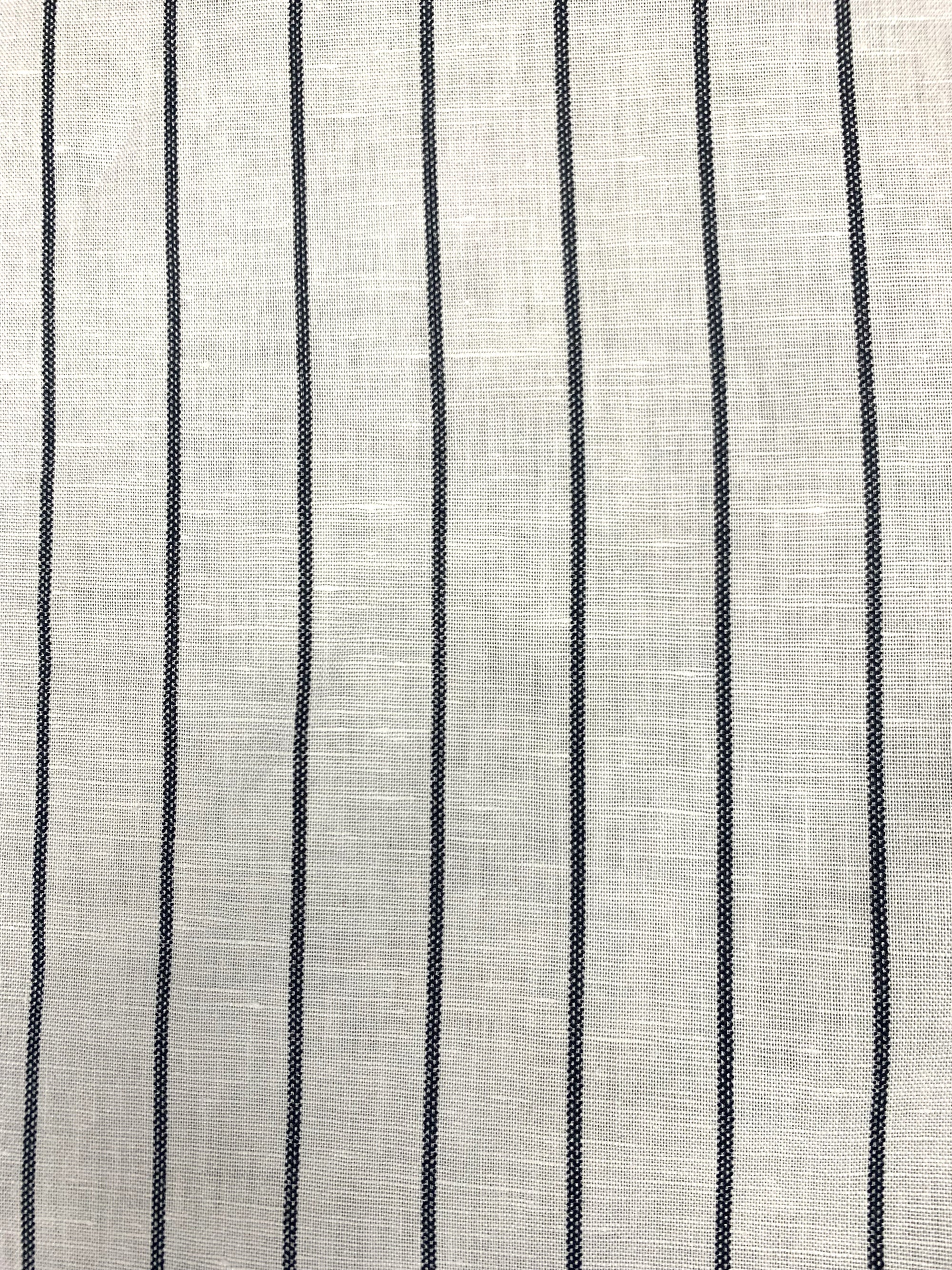 White linen cotton fabric with black stripes in a spiral in one inch increments horizontally
