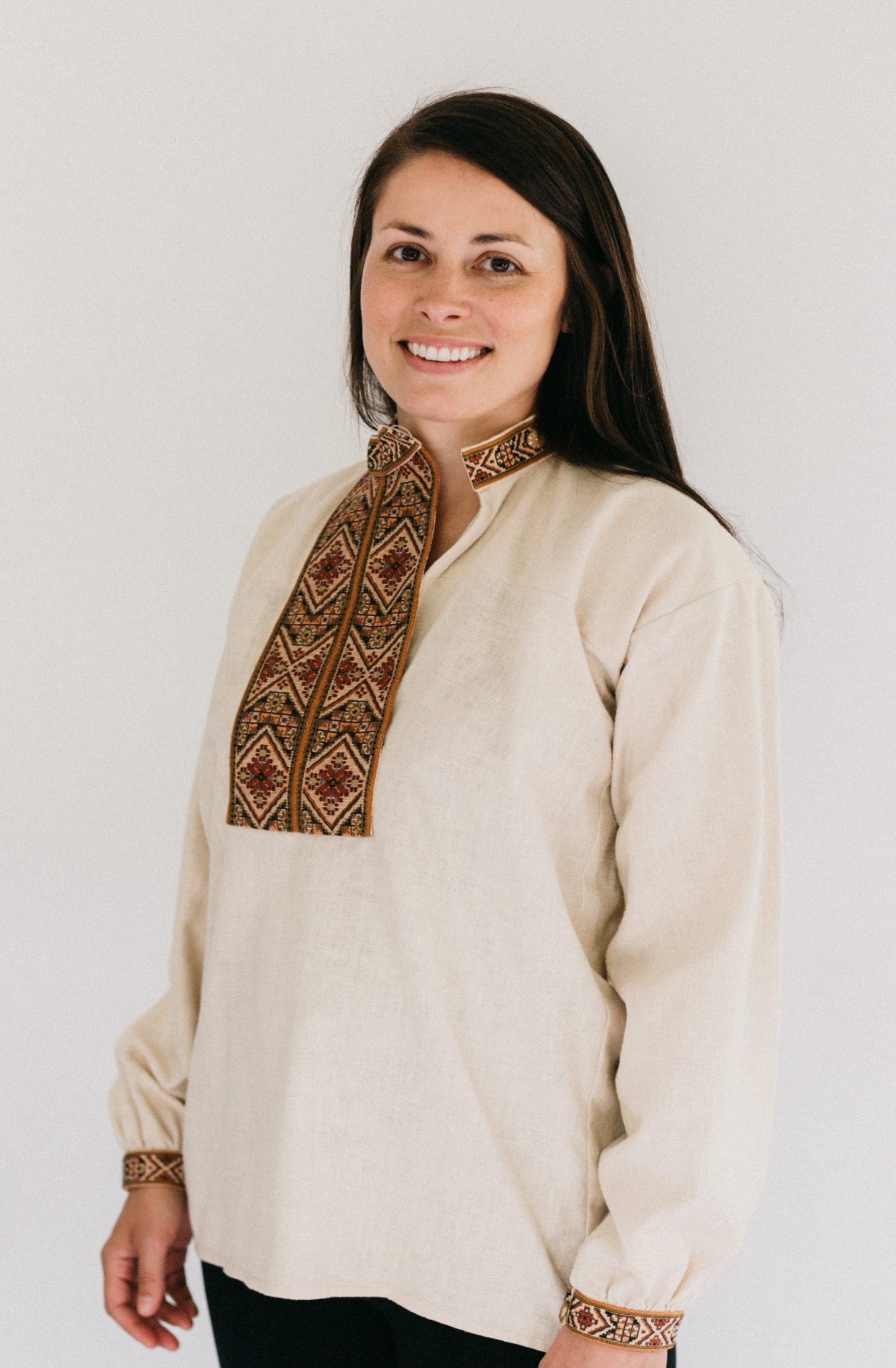 Woman wearing View B with embroidered neck opening and sleeve cuffs.  Shirt is unbuttoned to show side neck opening.