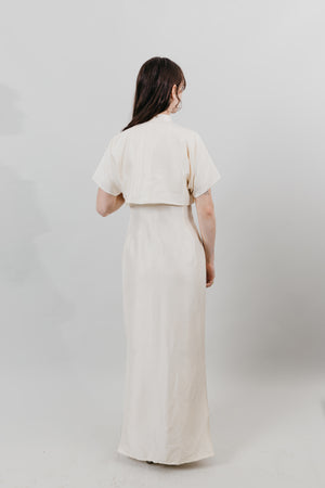 Back View of Woman wearing a floor length white cheongsam.
