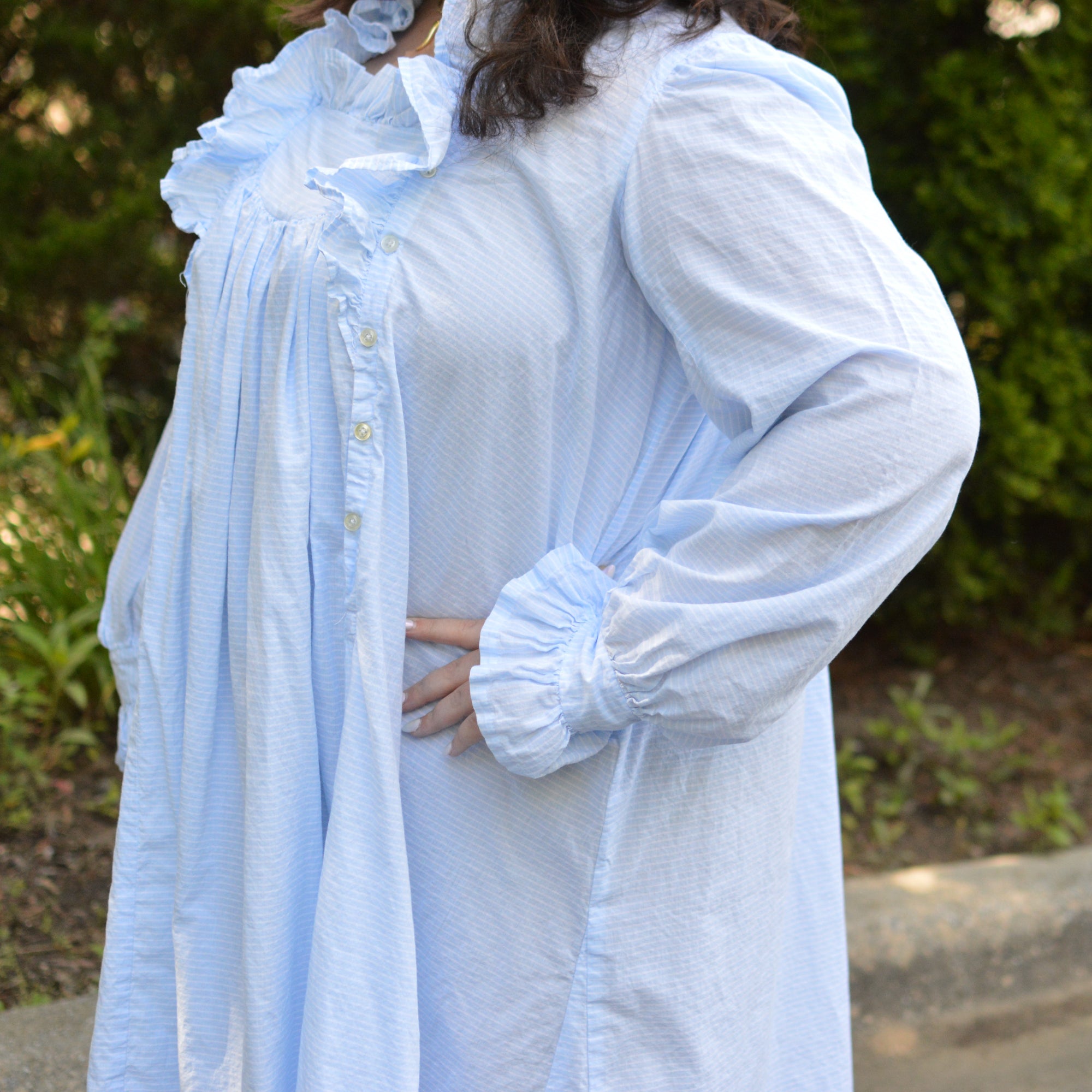 Side view of blue ruffled nightgown with side buttoned placket.