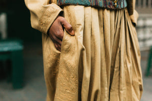 Close-up of gold embroidered (cording) Algerian Suit pants pocket with a blurred background