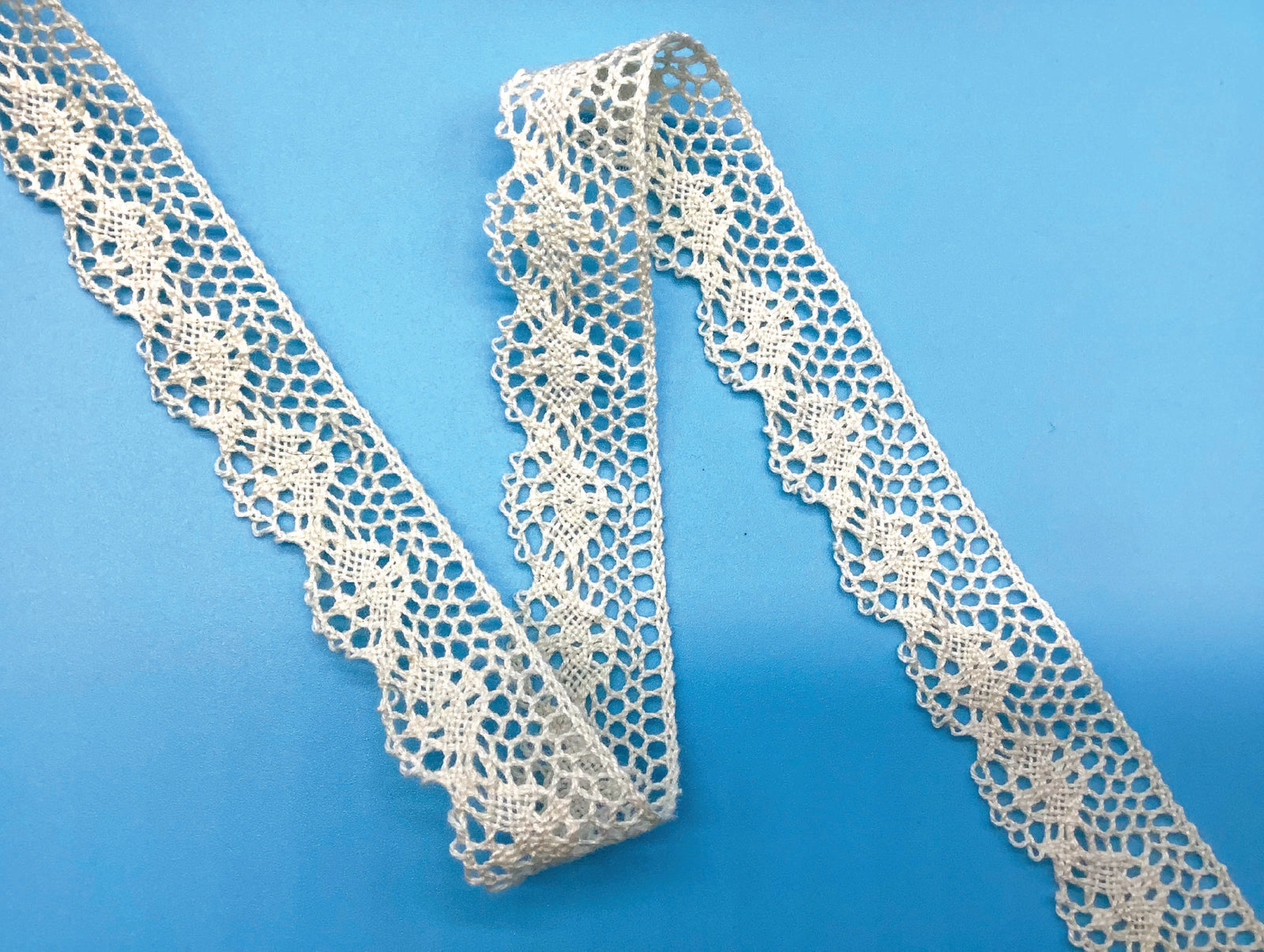 off white edge lace on  a blue background