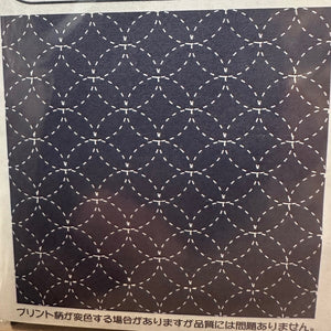 Patterned paper with geometric design on a dark background