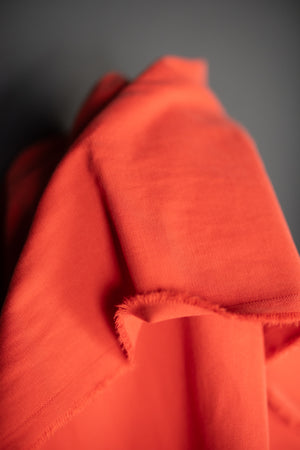 close up Sanded twill fabric in a bright red orange color