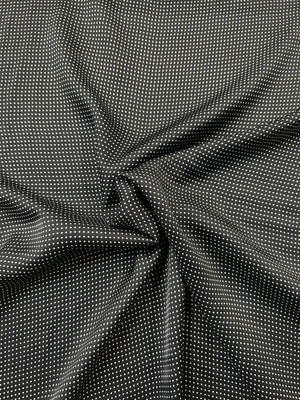Close-up mini black and white polka dot fabric.