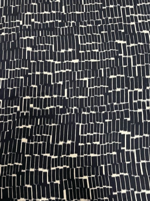 Pattern of navy and white rectangles on a dark background