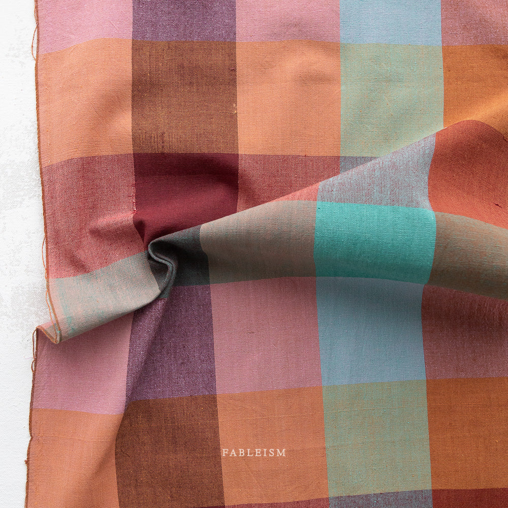 Multicolored checkered fabric with pinks, purples, oranges blues and greens, summer and autumn colors.