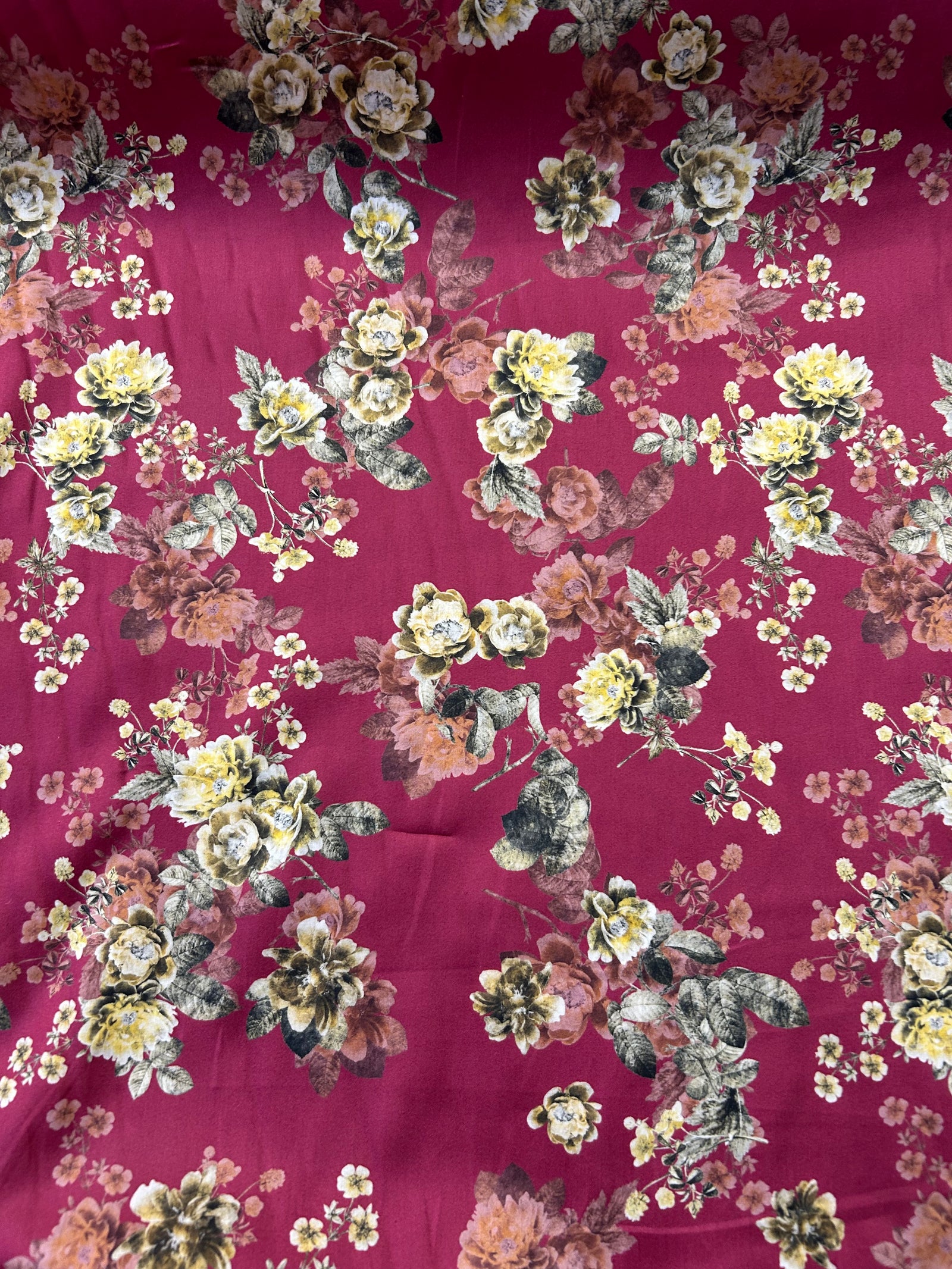 Cotton satin batiste is lightweight and very soft with a satin feel. It has a floral print with yellow roses on a burgundy background.