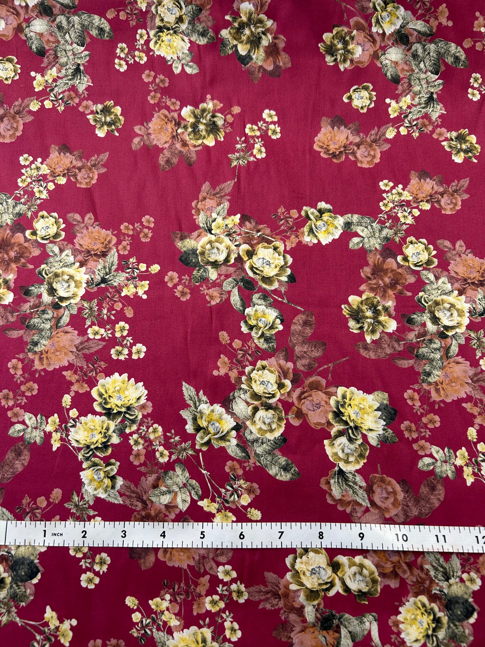 Cotton satin batiste is lightweight and very soft with a satin feel. It has a floral print with yellow roses on a burgundy background.