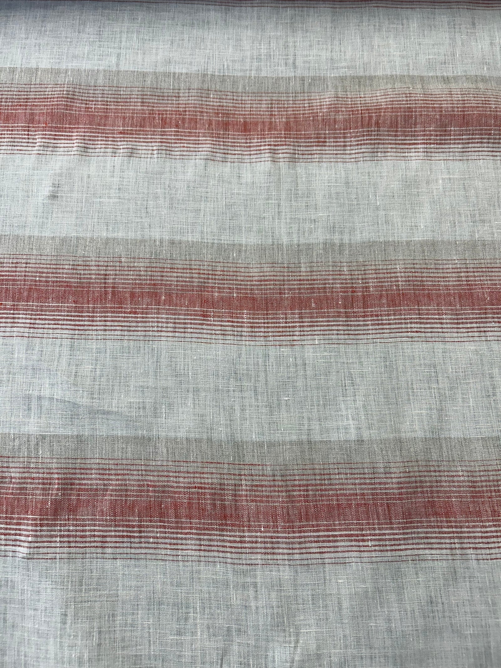 Red and white stripe linen fabric in a swirl.