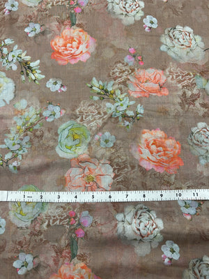 This is a cotton voile, with large white and peach blooming peonies mixed with delicate cherry blossom-like sprigs on a pale light brown background with a ruler for scale on a brown background