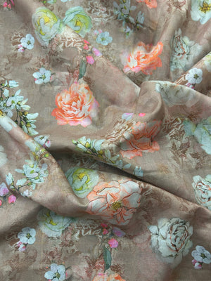 This is a cotton voile, with large white and peach blooming peonies mixed with delicate cherry blossom-like sprigs on a pale light brown background.