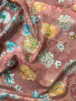 Draped floral patterned fabric with peonies/roses of white, yellow, and blue  on a pinkish-brown background.