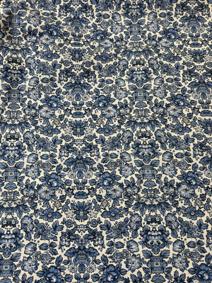 Blue floral cotton canvas fabric on a ecru background.