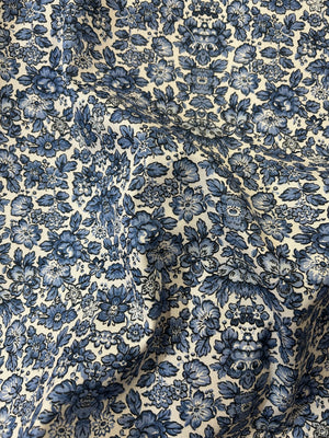 Floral patterned fabric with blue flowers on a beige background
