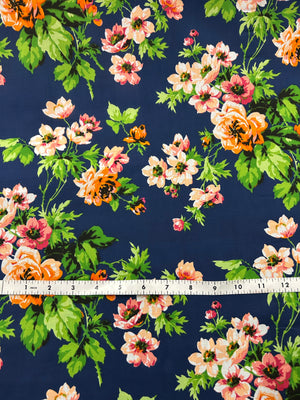 Floral fabric pattern with a measuring tape at the bottom on a navy background