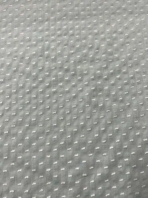 Close-up of white swiss dot fabric.with 