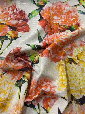 Floral fabric with orange, pink, and yellow flowers on a white background