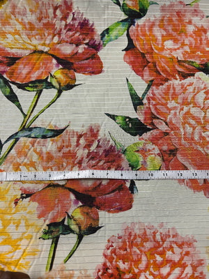 Floral fabric pattern with a ruler for scale on a beige background