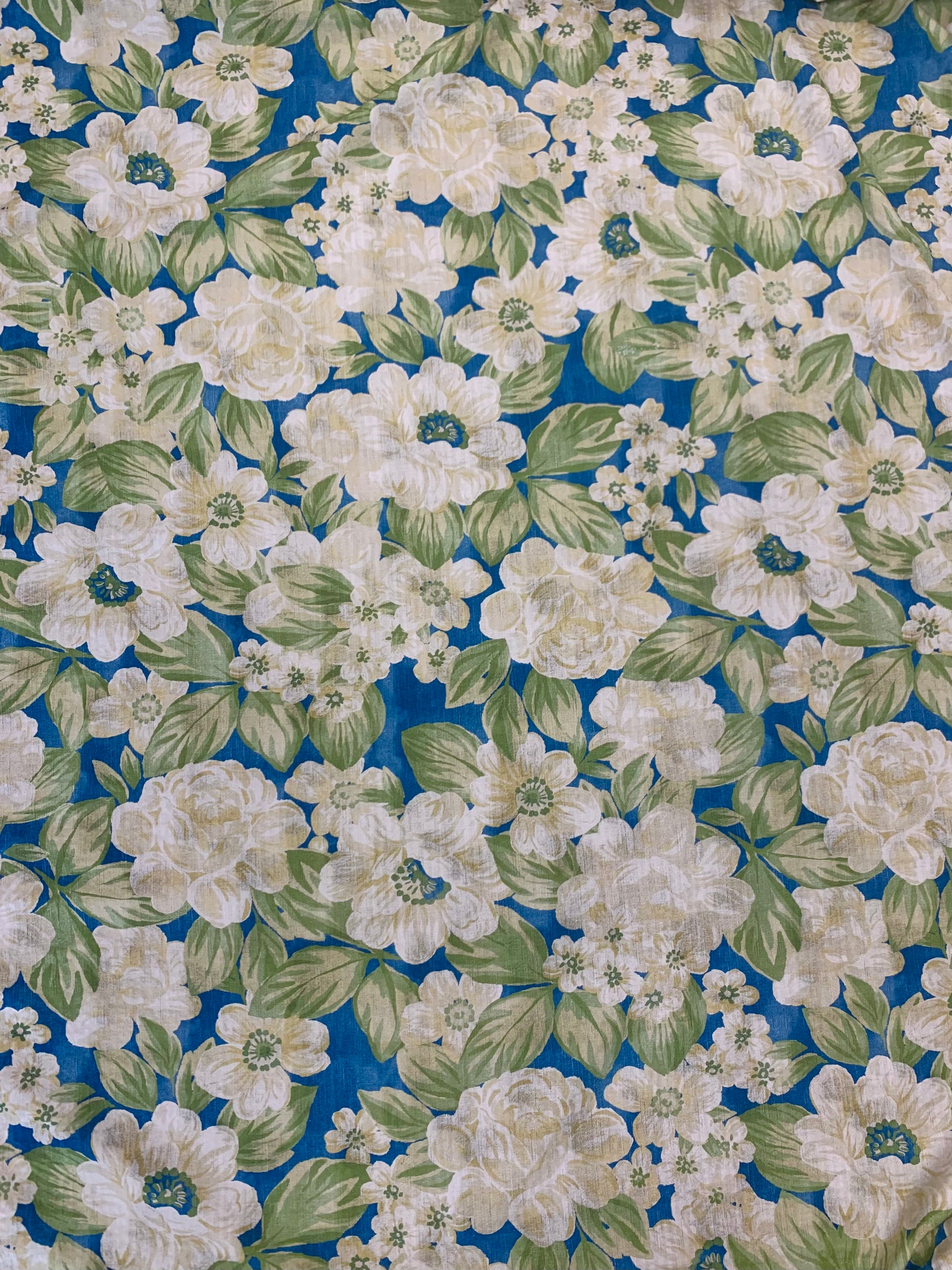 flat cotton seersucker in a royal blue with a beige and green rose floral print