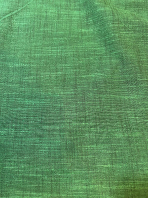 Handloom cotton fabric in a bright green color.