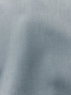 Close up of pale blue light wash denim fabric.