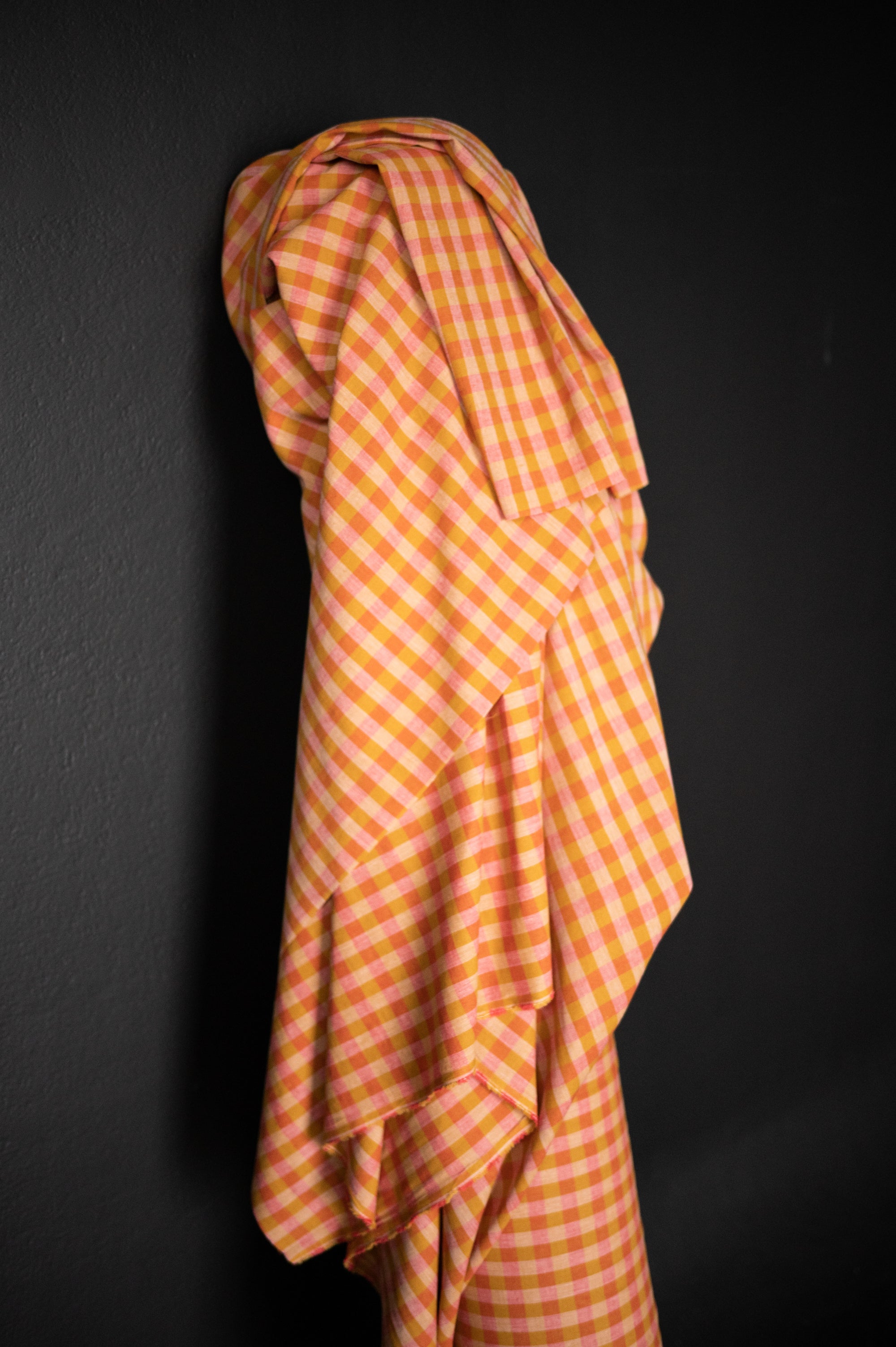 Pink and Yellow gingham Cotton/linen fabric on a dark grey background