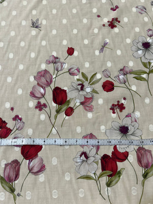 Floral pattern with red and purple tulip flowers on an ecru background with white polka dots and a ruler for scale.