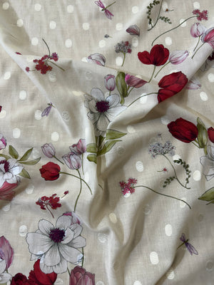 Floral fabric with red, pink, and green tulip flowers on a beige background with white polka dots.