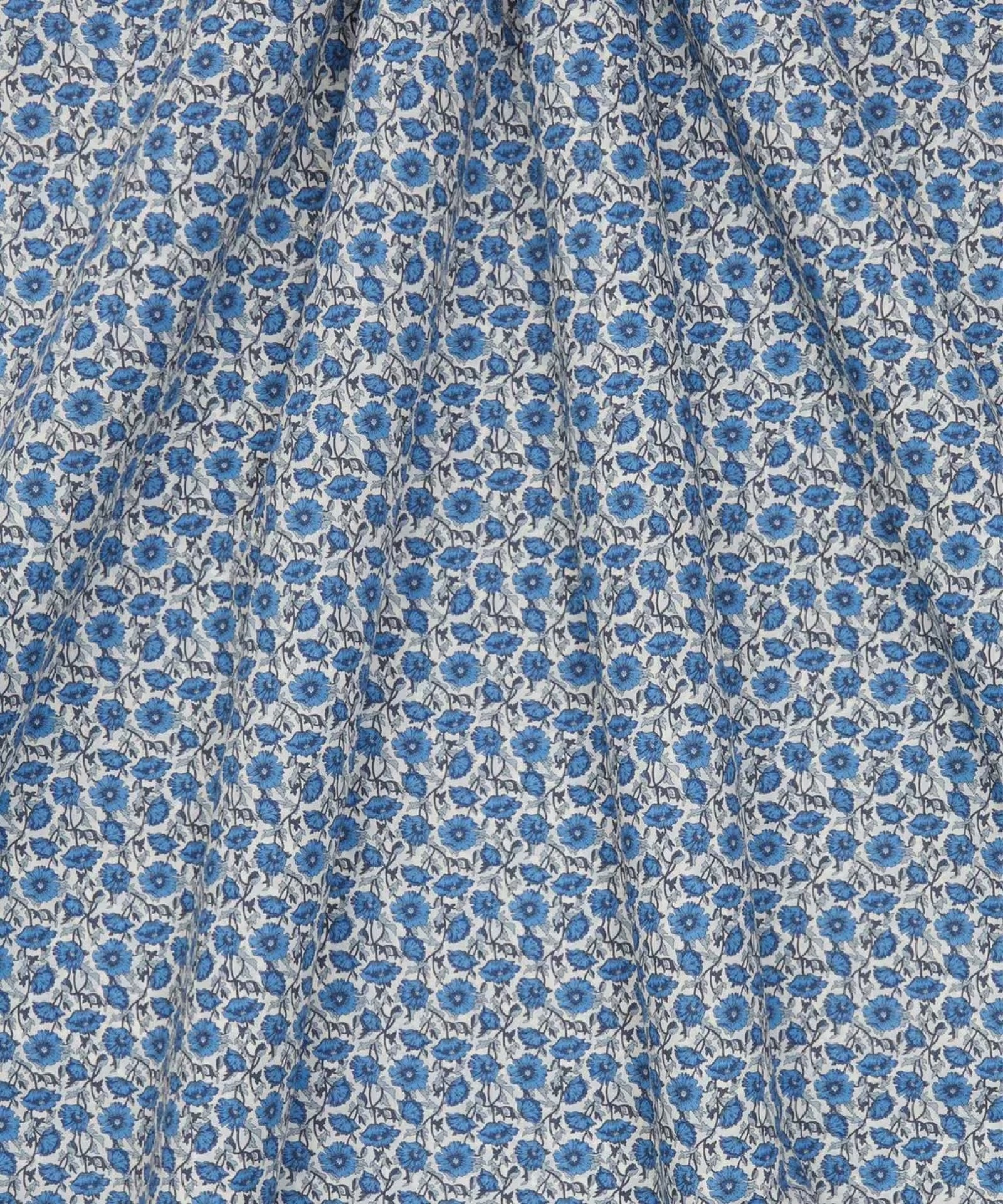 Draped Liberty of London cotton tana lawn in a  beautiful, vibrant print of blue poppies with a white background.
