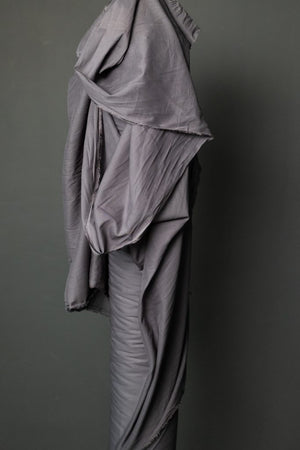 roll of powdered grey fabric on a dark grey background