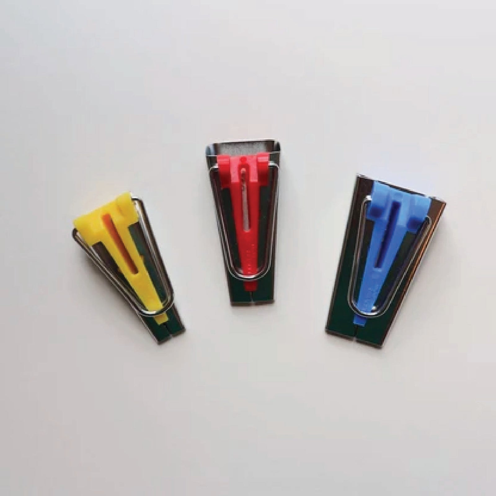 three bias tape makers on a white table 