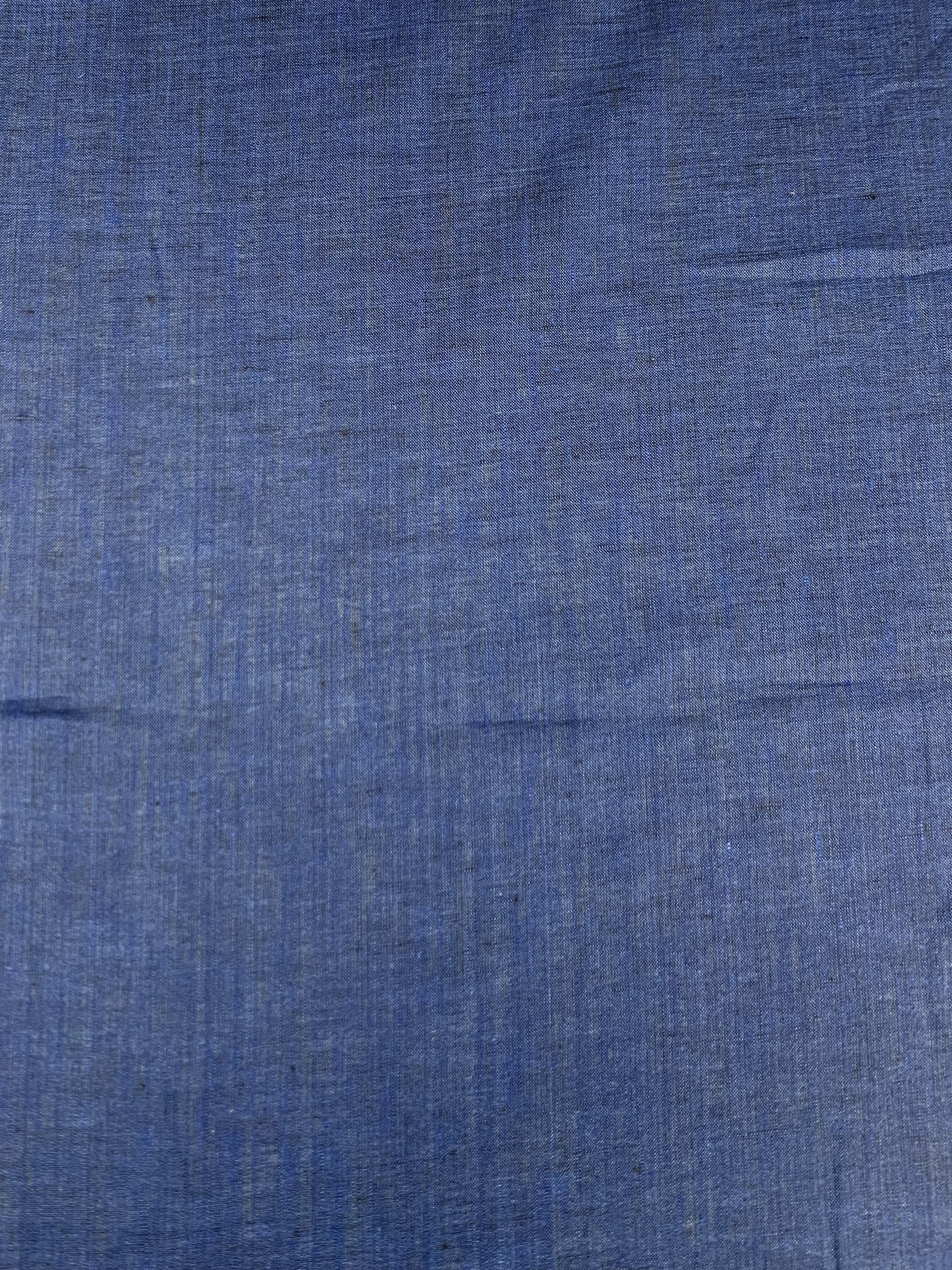 Cobalt blue linen fabric laid flat.