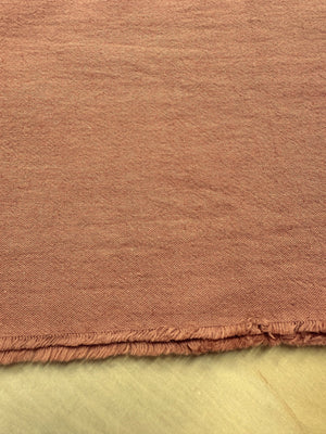 section of burnt orange colored cotton/linen fabric on a table