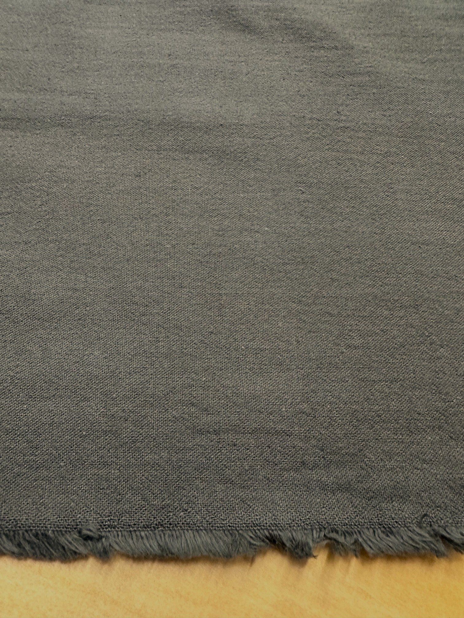 section of brown fabric on a wooden table