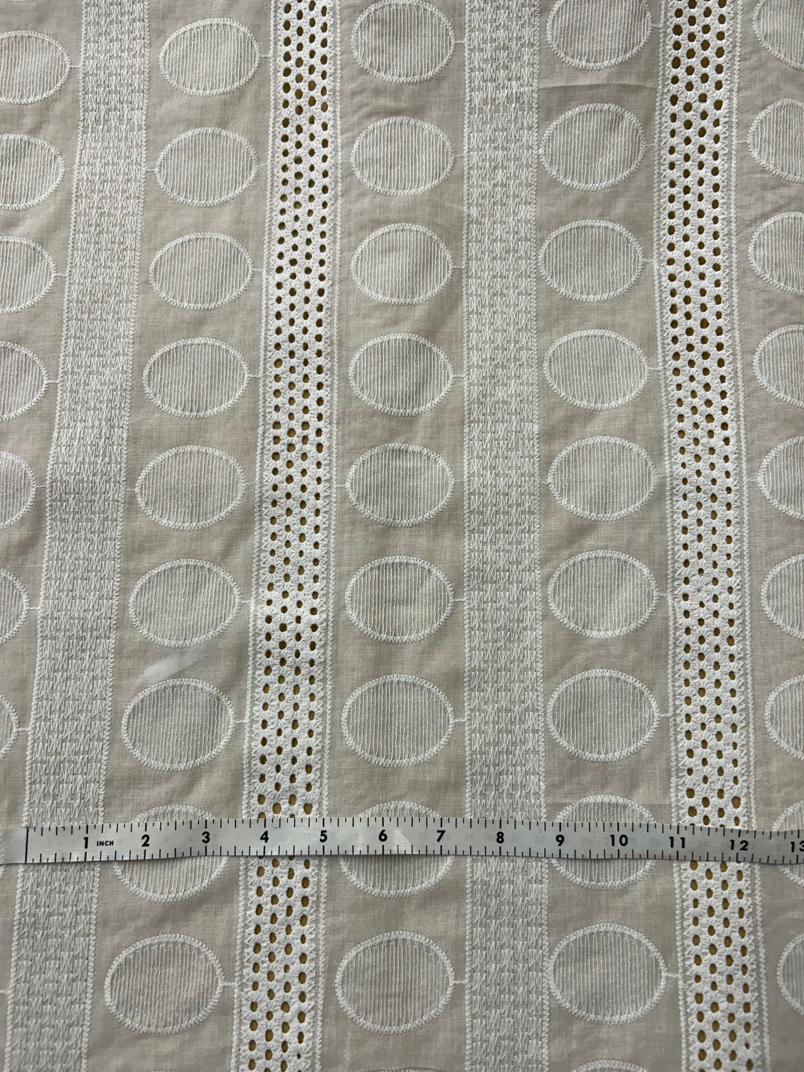 Close-up of a textured fabric with circular patterns in gray tones.