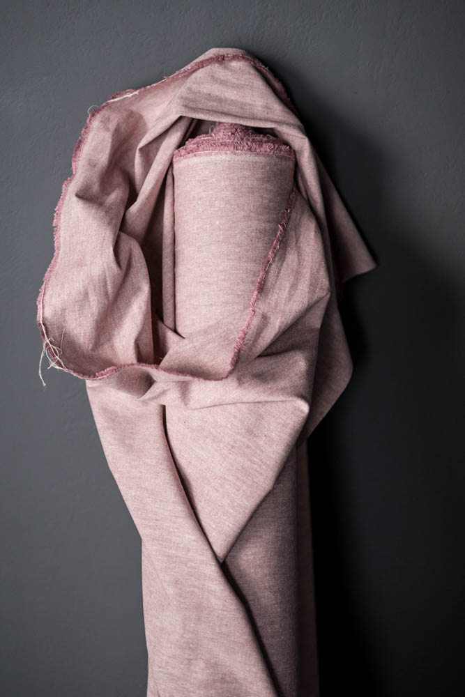 Pink Organic Cotton/Hemp Chambray  fabric on a grey background
