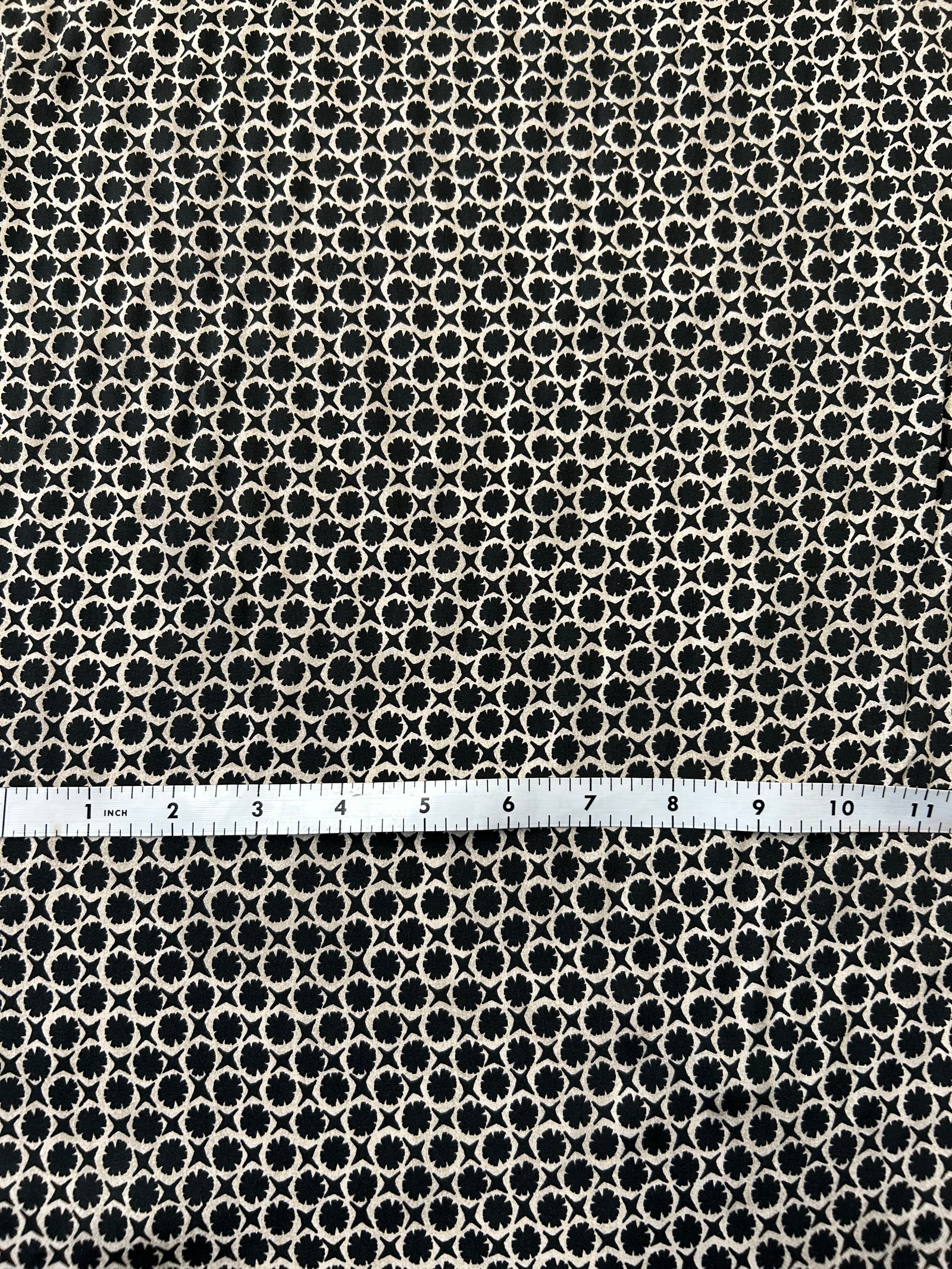 vintage-style, black and tan geometric print, made of viscose with a satin finish.