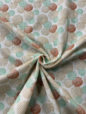 Close-up of patterned Linen fabric with a a retro abstract polka dot print fabric in mint, beige, and rust on an ivory background. The circles vary in size and are filled with fine diagonal stripe textures, creating a layered geometric look with a hand-printed feel.