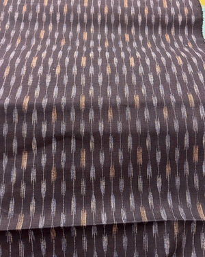 Textured navy fabric with a pattern of small, evenly spaced lines on a dark background