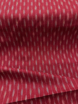 Textured red fabric with a pattern of small, evenly spaced lines 