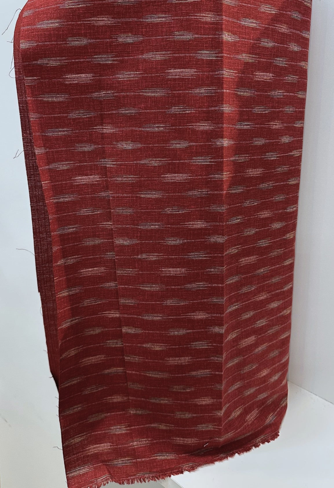Red fabric with a subtle pattern on a white background