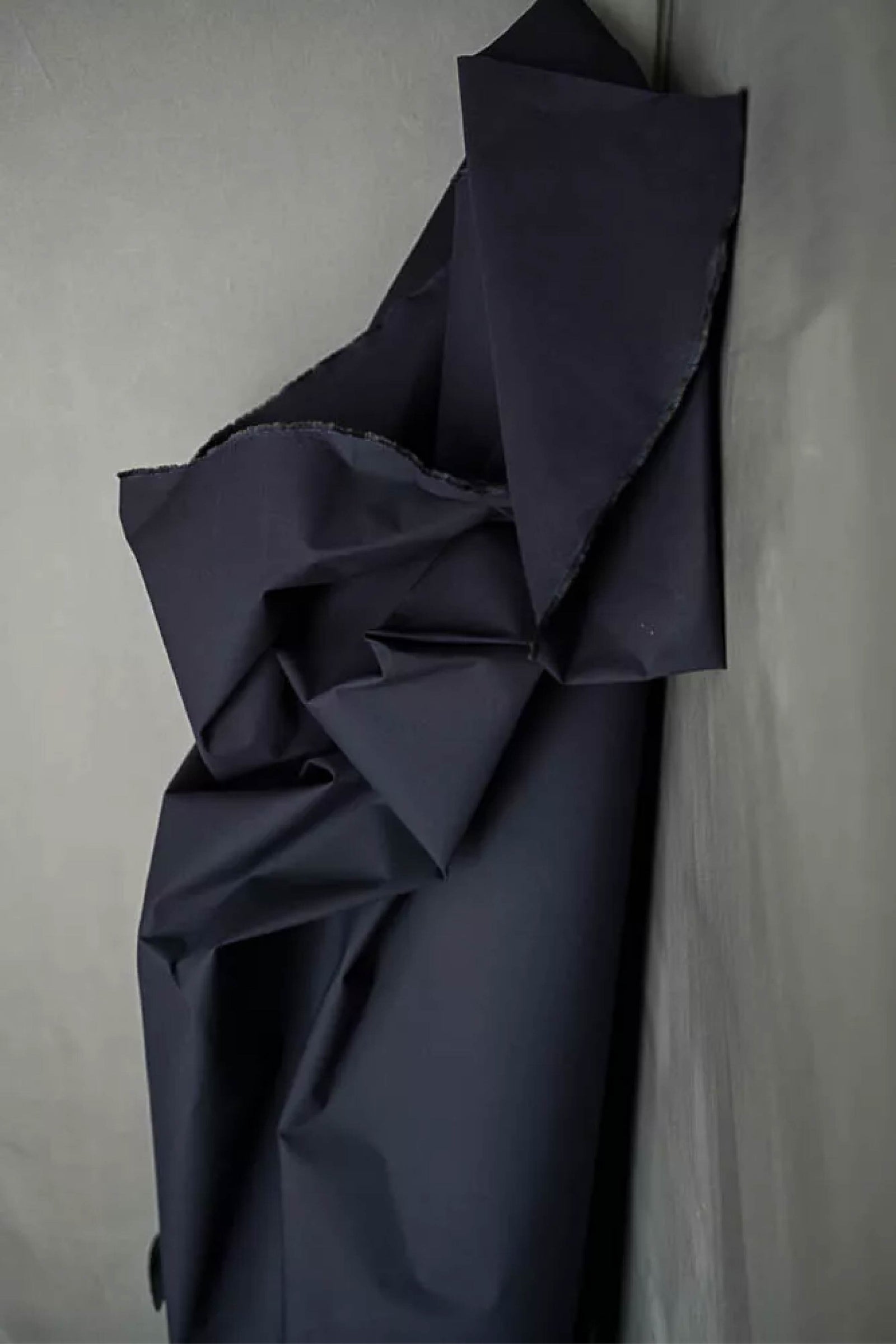 Dark blue fabric against a gray background