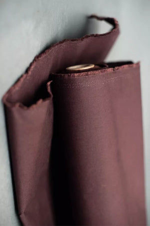 Close-up of a red oilskin fabric on a light gray background