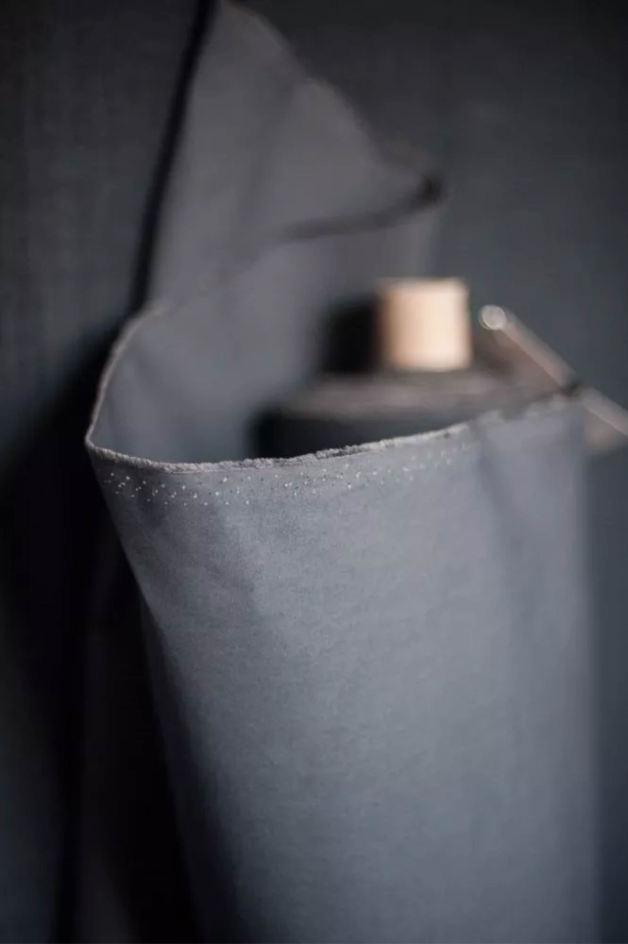 Close-up of a dark gray fabric with a textured surface