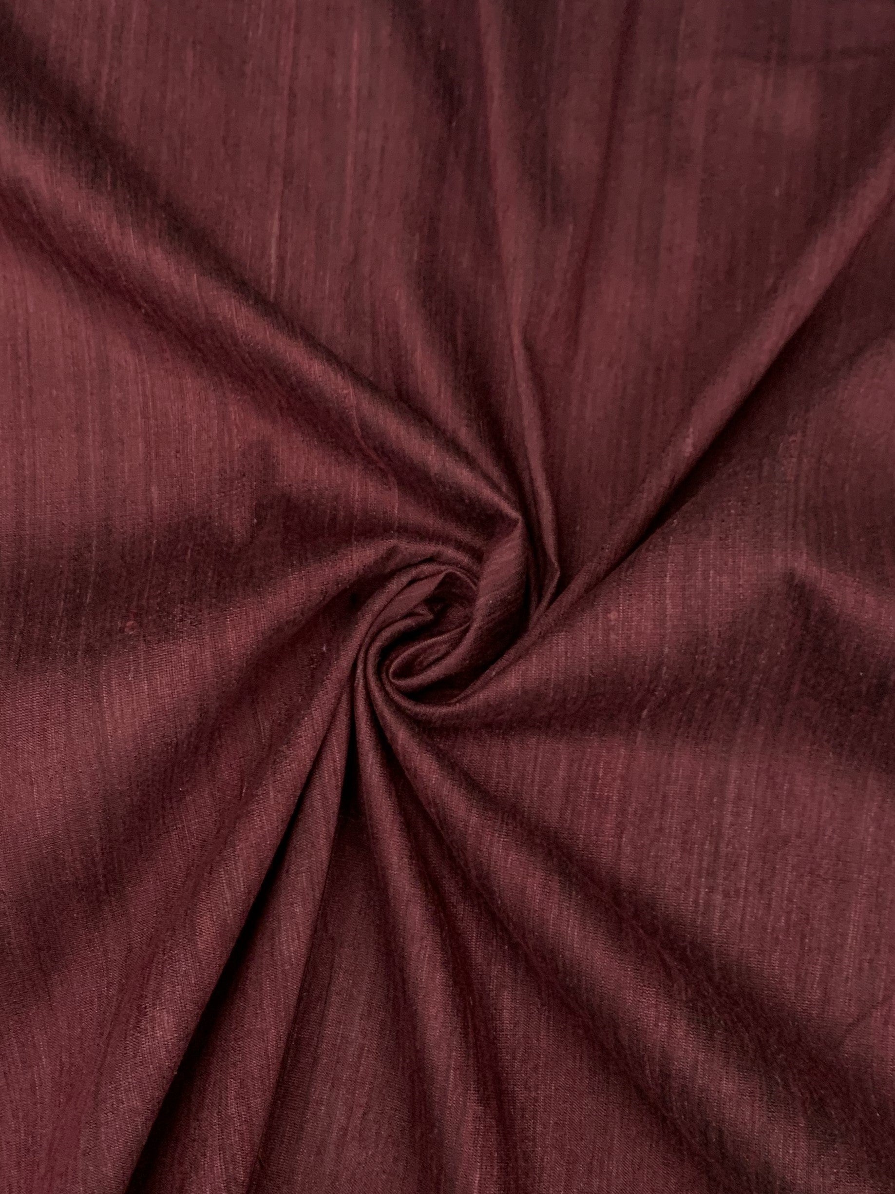 silk dupioni  fabric in wine in a spiral 