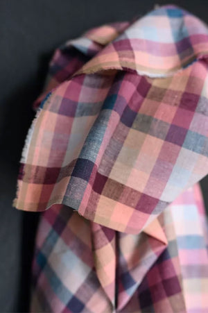 close up of cotton and linen blend in the shade range of pinks, blues and purple gingham