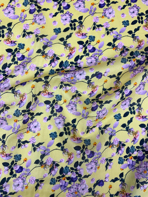  cotton lawn with purple and green flowers on a background of pastel yellow