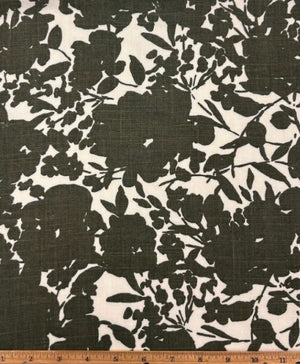 Italian linen with a green print of floral silhouettes on a white background with a ruler at the bottom for scale.